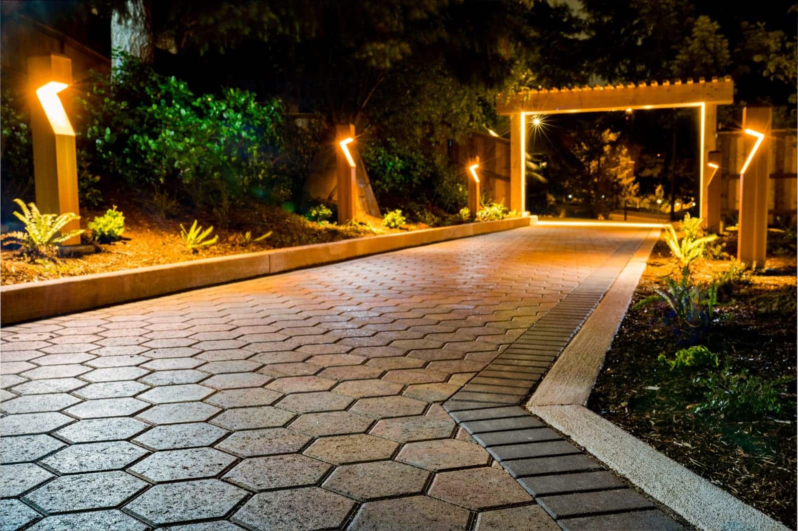 Paver walkway installation winding through a landscaped Oregon yard