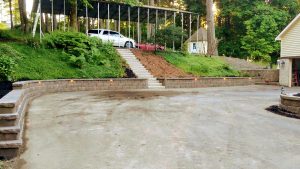 retaining wall defines the edge of the garage and parking area